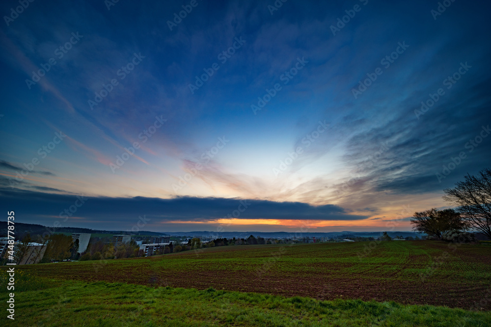Panoramic sunrise over a green field