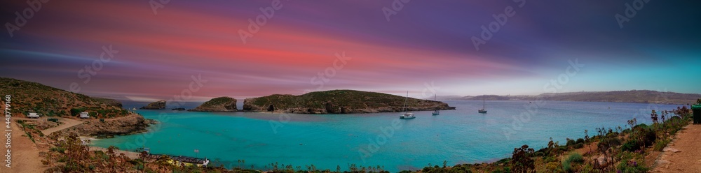 Blue lagoon on Malta island with sunset sky