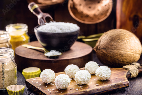coconut balls, coconut candy with ingredients in the background, rustic and healthy cuisine