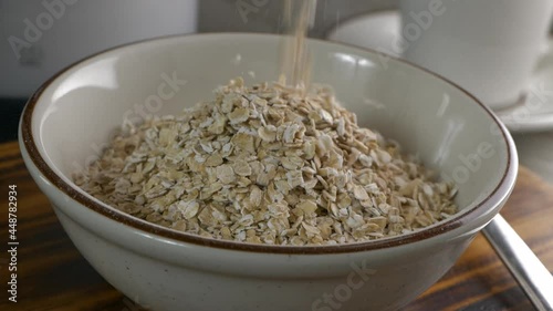Pouring instant oatmeal into a bowl super slow motion photo
