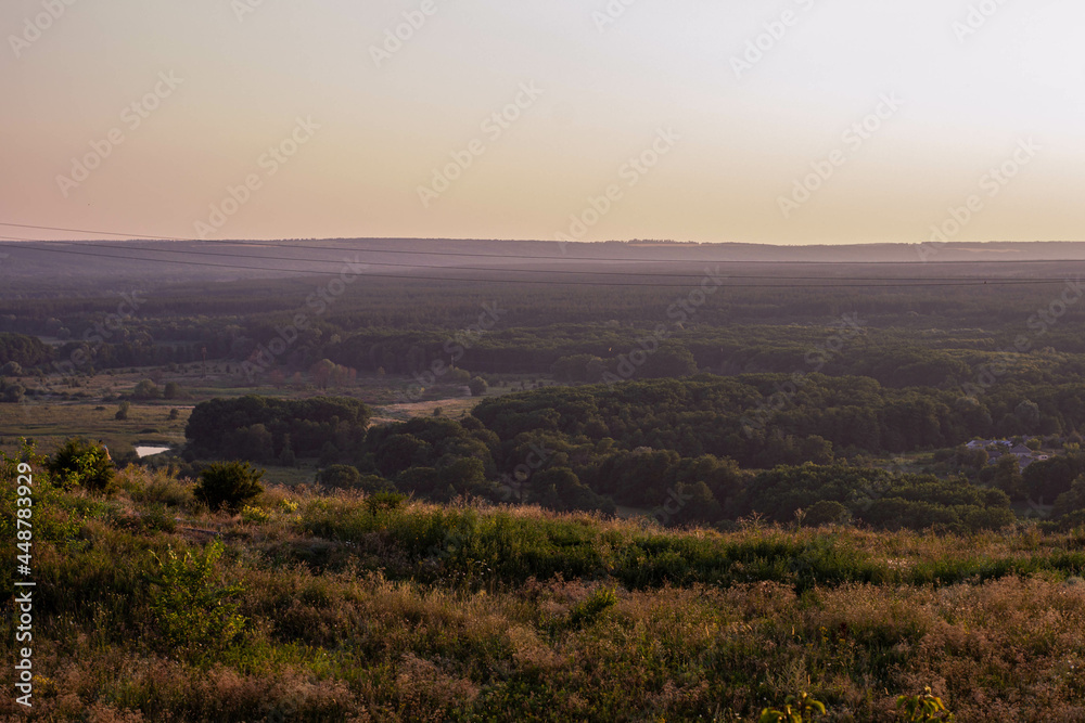 Panorama overlooking the city from the mountain at sunset. Ukraine, city of Izium August 2, 2021