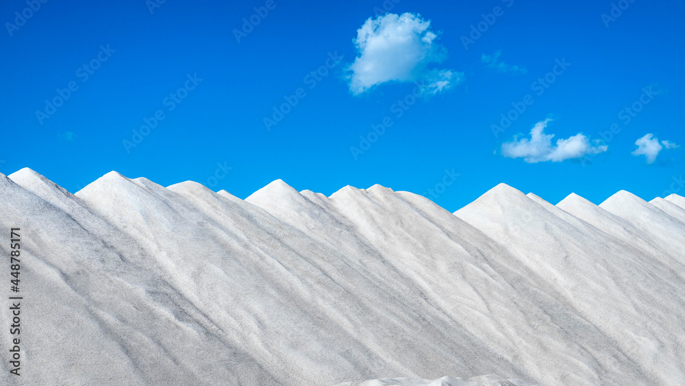 Piles of salt against a blue sky.
