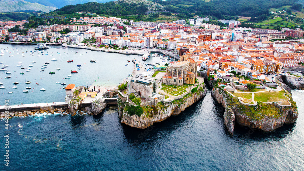 In this imagen you can see Castro Urdiales, its port, its cliff, and its buildings- All of this is ubicated in Cantabric see, in Cantabria, Spain. 