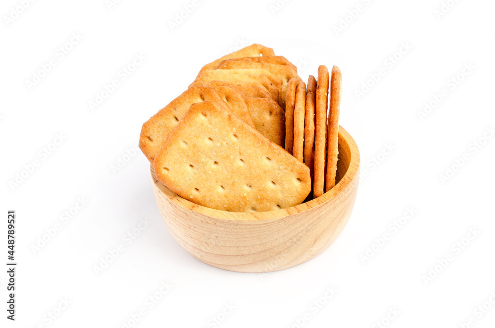 Group of square cracker or biscuit pile in wooden bowl on white background