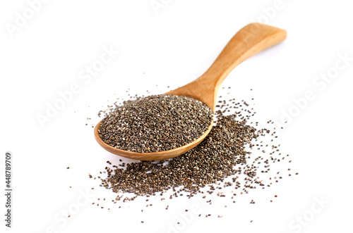 Dry organic chia seed pile in wooden spoon on white background