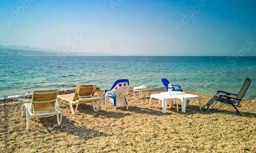 Sandy and sunny beach of the Red Sea with chairs and deck-chairs for happy vacation and relaxation after restrictions due to epidemic illness, Red Sea, Middle East © sergei_fish13