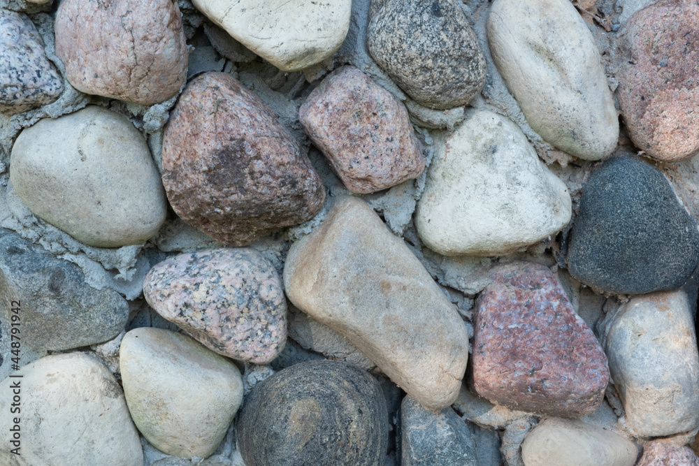 A background of beautiful multi-colored textured stones, fastened with cement. A background of beautiful multi-colored textured stones, fastened with cement.