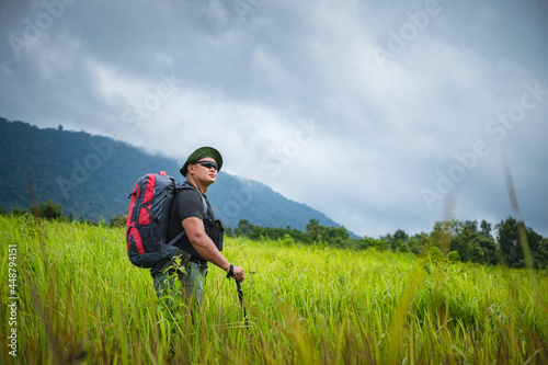 Backpacker trekking to study nature of tropical forest for ecotourism. Tourist trekking to see the beauty of the tropical forest in Khao Yai National Park. UNESCO World Heritage Area, Unseen Thailand.
