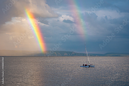 A bright double rainbow over the river © Vasilii