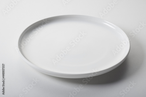 Round white plate on table photo