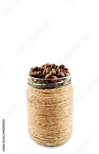 Roasted coffee beans in a glass craft jar, whole coffee beans in a brown jar. Isolate. Copy space. photo