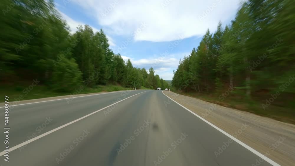 The concept of development of road communication of the country. The car is moving at high speed on the highway. Several cars on the road, shooting in motion. High quality. 4k footage. The concept of development of road communication of the country. The car is moving at high speed on the highway. Several cars on the road, shooting in motion. High quality. 4k footage.