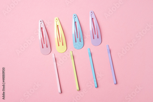Colorful pastel accessories hairpin on pink background  close up  trendy modern from past