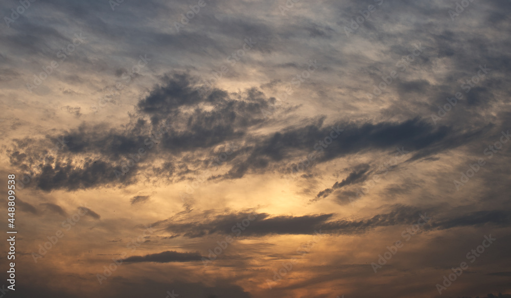dramatic clouds float across the blue sky dramatic clouds float across the blue sky