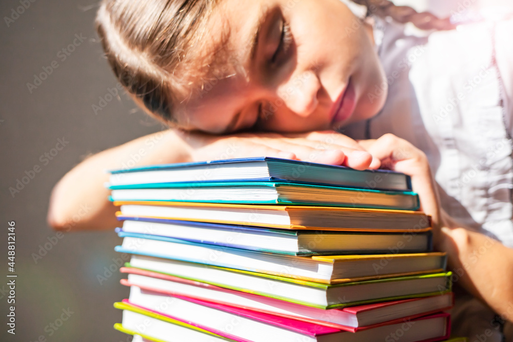 Schoolgirl sleeping on a stack of textbooks. Schoolgirl sleeping on a stack of textbooks.
