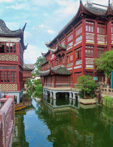 Chinese Traditional Architecture with a River and Boats next to Buildings