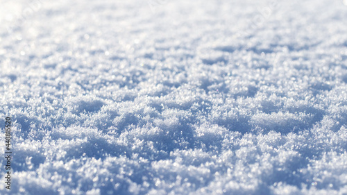 Texture of fluffy snow in sunny weather, winter background