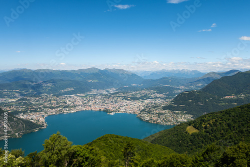 Fototapeta Naklejka Na Ścianę i Meble -  Gorgeous view from the hill top at Balcony of Italy, over Lake Lugano, city Lugano and other cities. The view go far into Switzerland, all to the way to the Swiss alps. Shot from the Italian side of t