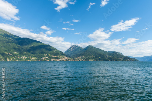 View over the beautiful, gorgeous lake Como seen from the small village of Santa Maria Rezzonico. It is a beautiful sunny summer day, with blue sky and a few clouds. There are boats on the lake. © brianholm