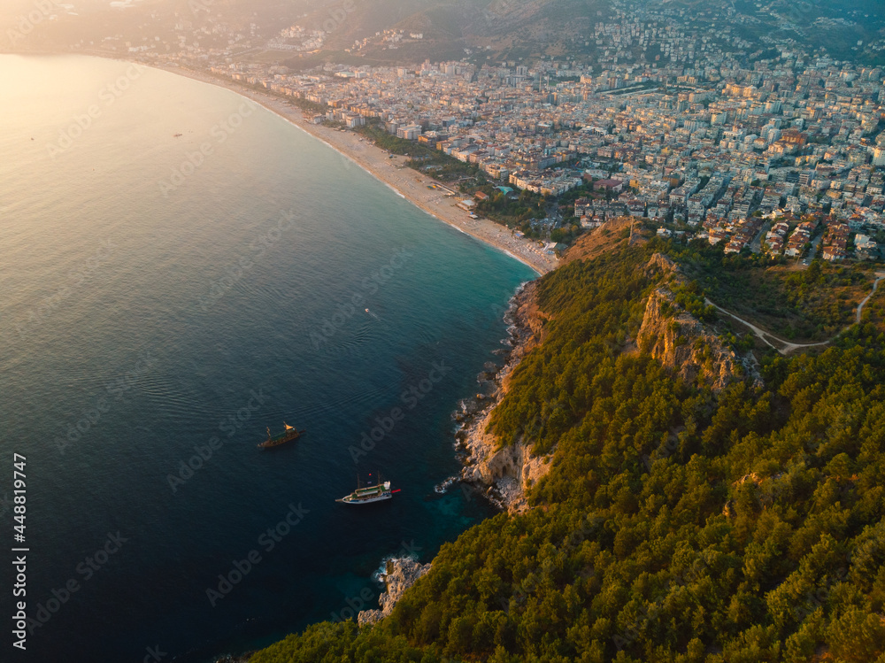 Aerial view of Kleopatra beach, lake. Alanya in southern coast of Turkey, Summer day. Travel and vacation. Kalesi Castle. Mountain. Ships and boats in the mediterranean