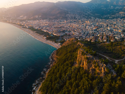 Fototapeta Naklejka Na Ścianę i Meble -  Aerial view resort city Alanya in southern coast of Turkey, Summer day. Travel and vacation. Kalesi Castle. Mountain. Ships and boats in the mediterranean