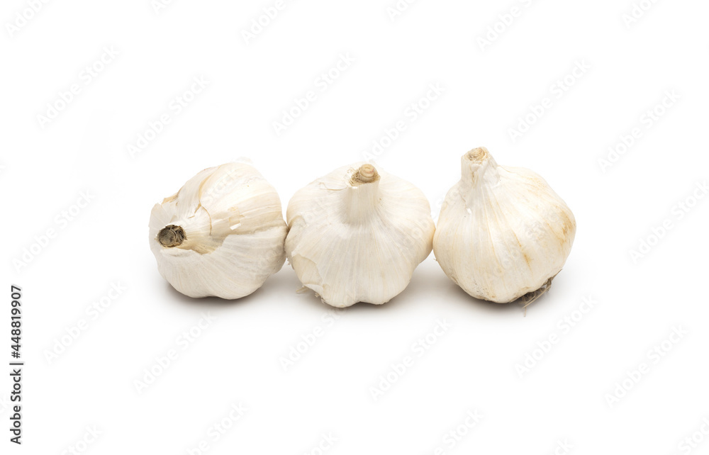 Three organic fresh garlic on isolated white background Three organic fresh garlic on isolated white background