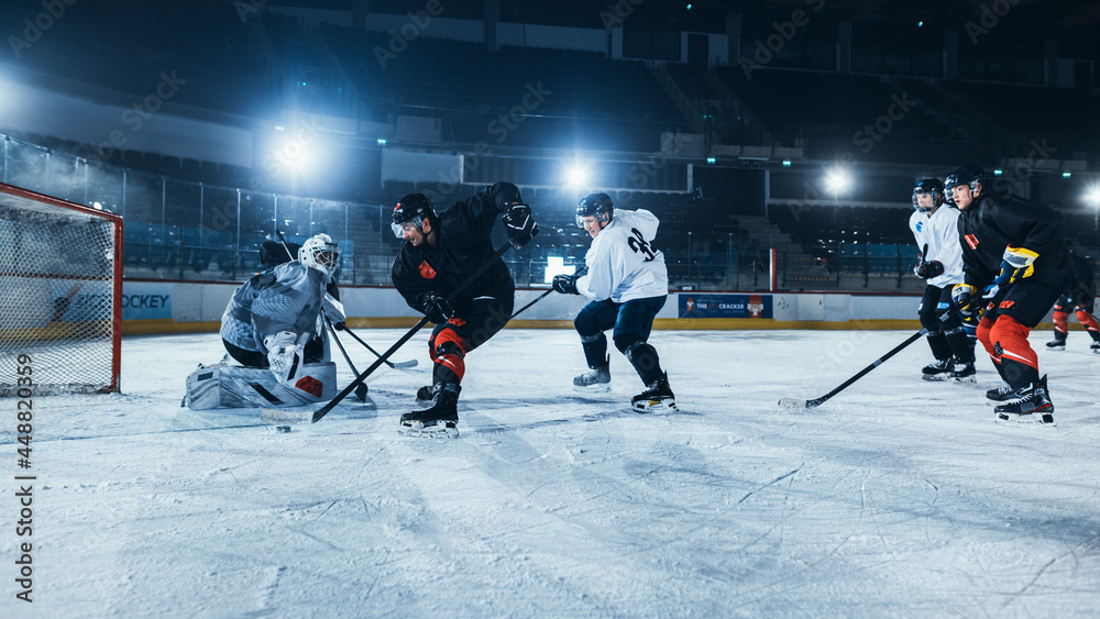 Fototapeta premium Ice Hockey Rink Arena: Professional Forward Player Breaks Defense, Hitting Puck with Stick to Score a Goal. Game Near Gate or Goal. Important and Tension Moment in Sport Full of Emotions.