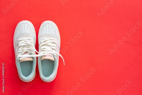 A pair of sneakers isolated on red background. 
