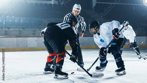 Ice Hockey Rink Arena Game Start: Two Players Brutal Face off, Sticks Ready, Referee Drops the Puck, Athletes fight for It. Intense Game Wide of Energy Competition, Speed. Sport Full of Emotions.