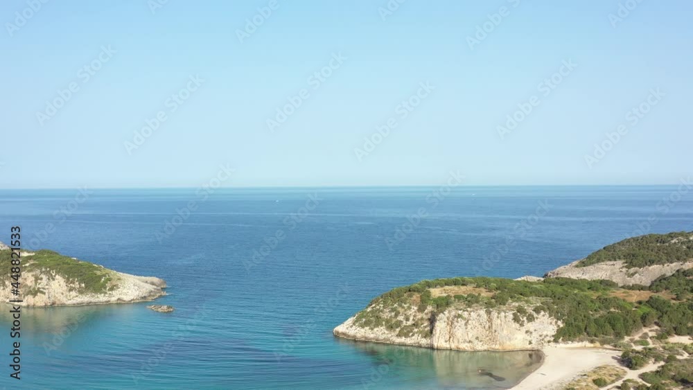 Aerial drone video of semicircular sandy beach and lagoon of Voidokilia, one of the most iconic beaches in Mediterranean sea, with crystal clear turquoise sea, Messinia, Greece Aerial drone video of semicircular sandy beach and lagoon of Voidokilia, one of the most iconic beaches in Mediterranean sea, with crystal clear turquoise sea, Messinia, Greece