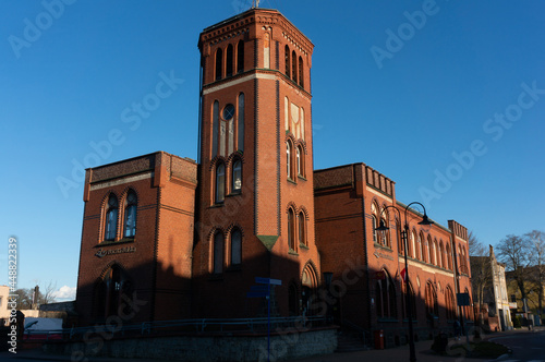 Post office from 1905. Evening light floods the building. Slawno, Poland. photo