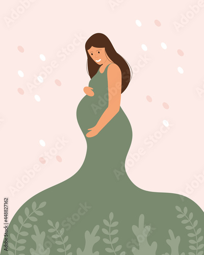 Young expectant mother hugs her big belly. Green dress on a pregnant woman. Universe and love. Pregnancy and motherhood.