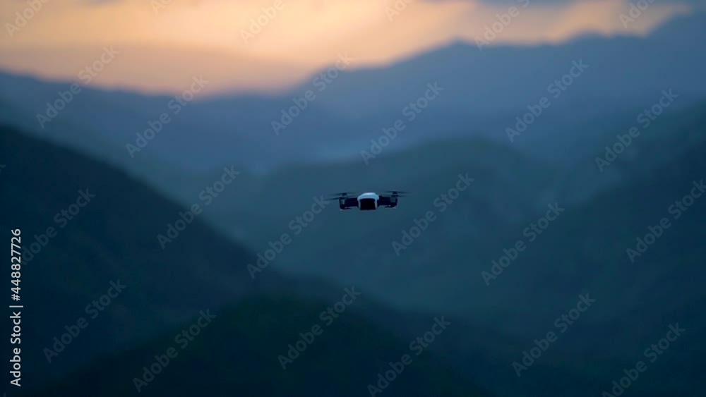 Closeup slow motion of flying drone at sunset sky in mountains. Closeup slow motion of flying drone at sunset sky in mountains.