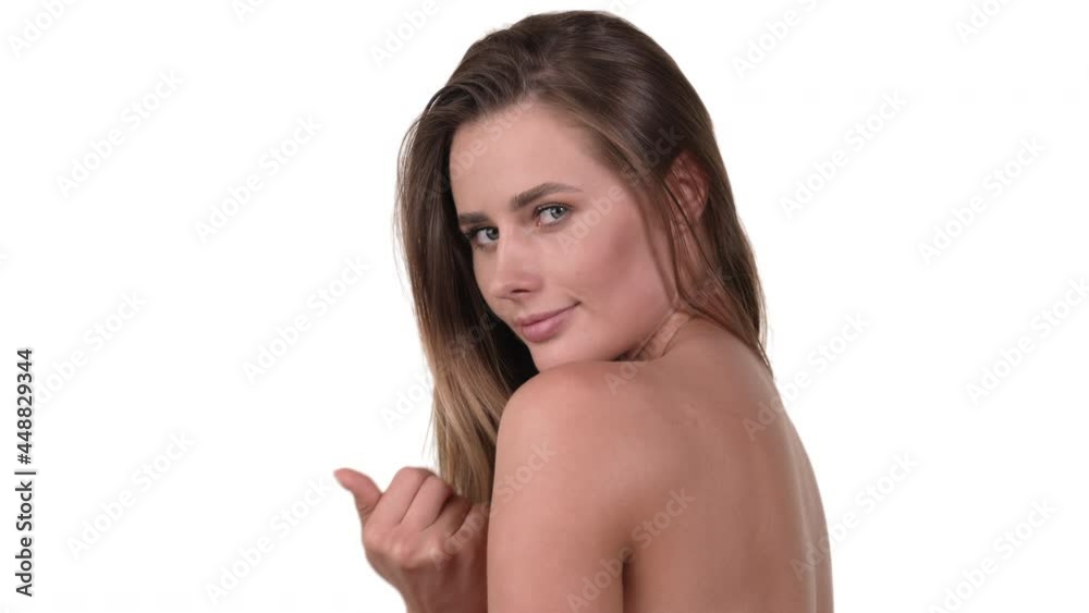 Portrait of a woman, hair down, calling with her finger, come hither gesture. White background.