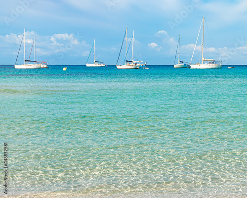 Boats in turquoise water beach in Spain