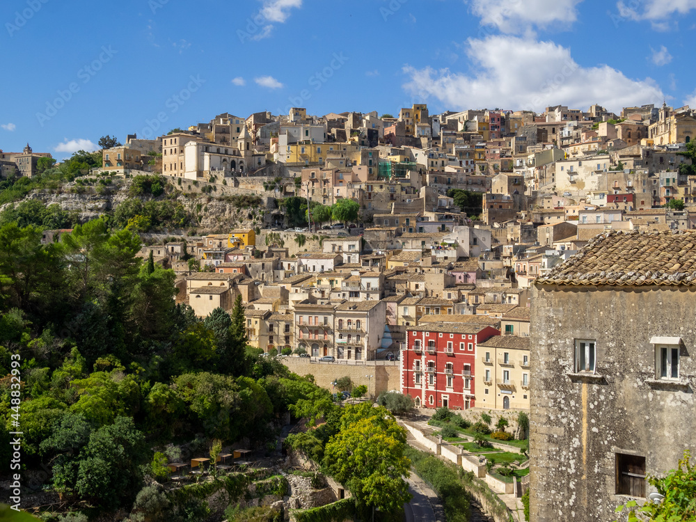 Ragusa buildings rolling down hill over Valle dei Ponti seen from Ibla