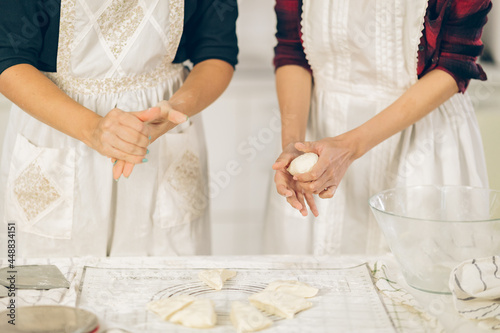 woman kneading dough on kitchen board © iStocker