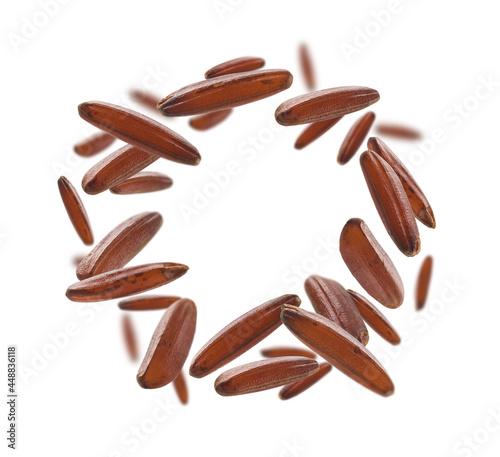 Raw brown rice levitates on a white background