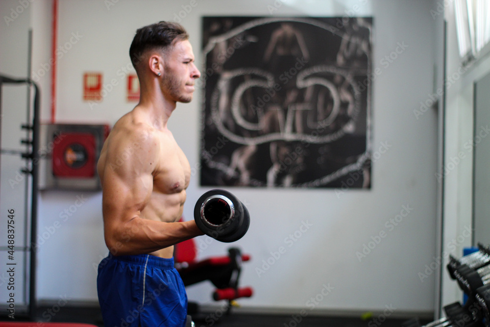 muscular young guy training in gym with suffering face muscular young guy training in gym with suffering face