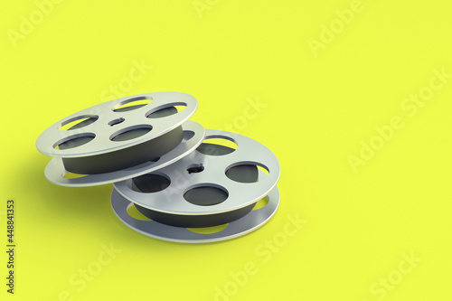Film reel in metal frame on yellow background. Cinematography tape. Retro technology. Cinema premiere. Documentary shooting. Copy space. 3d render