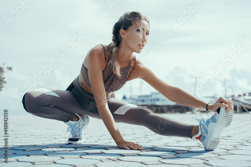 Beauty woman make fitness on the street, blonde hair, training, sport, sneakers, sport wear, yoga style
