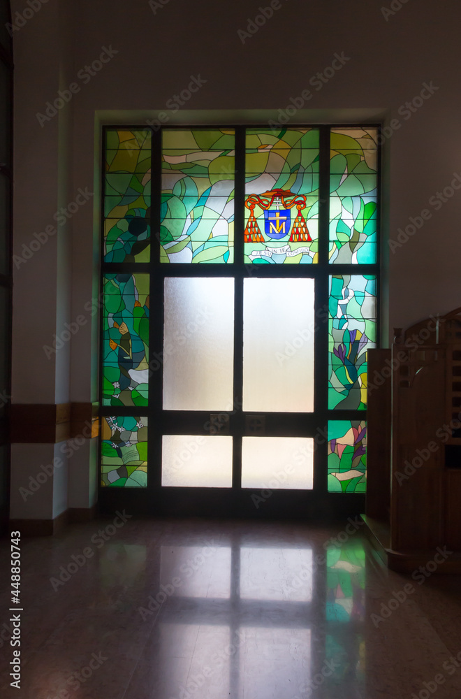 Zakopane, Poland, June 8, 2021: Interior of the Holy Cross Church in Zakopane. Stained glass window around the door with the coat of arms and the invocation of Cardinal Franciszek Macharski - obrazy, fototapety, plakaty 
