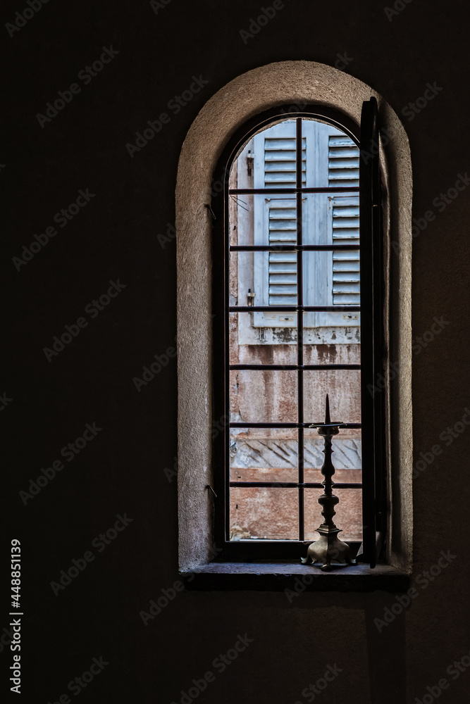 Window in an old church with a candlestick Window in an old church with a candlestick