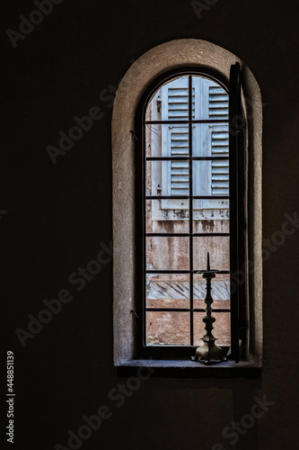 Window in an old church with a candlestick
