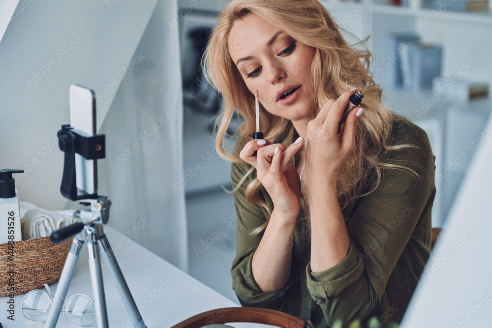 Attractive young woman vlogging about make up and beauty products Attractive young woman vlogging about make up and beauty products