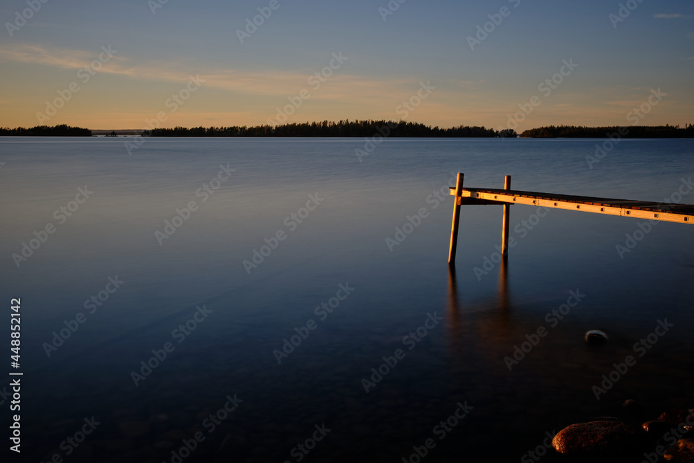 Jetty at a lake at sunset