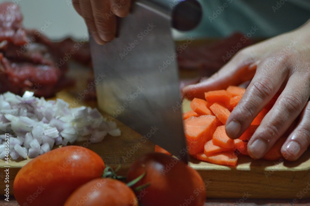 person cutting vegetables