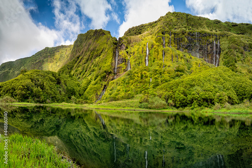 Azores scenic landscape, Flores island. Iconic lagoon with over 20 separate waterfalls on a single rockface, flowing into lake Alagoinha. Best travel destination in Portugal, amazing vacations place. photo