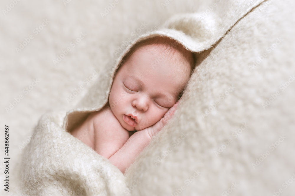 Newborn baby sleeping under a soft blanket Newborn baby sleeping under a soft blanket