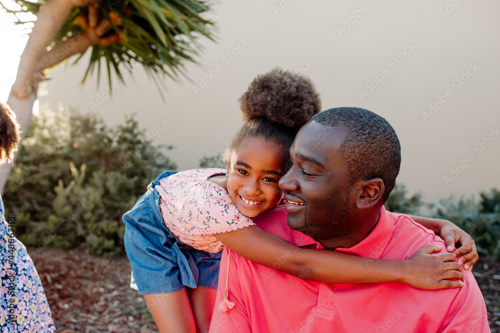 Sweet girl hugging dad outdoors Sweet girl hugging dad outdoors